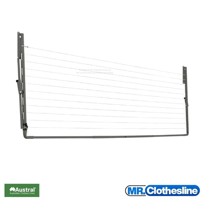 Austral Compact 39 Fold  Down Clothesline front view and the clothesline closed flat against a white wall. Colour Woodland Grey.