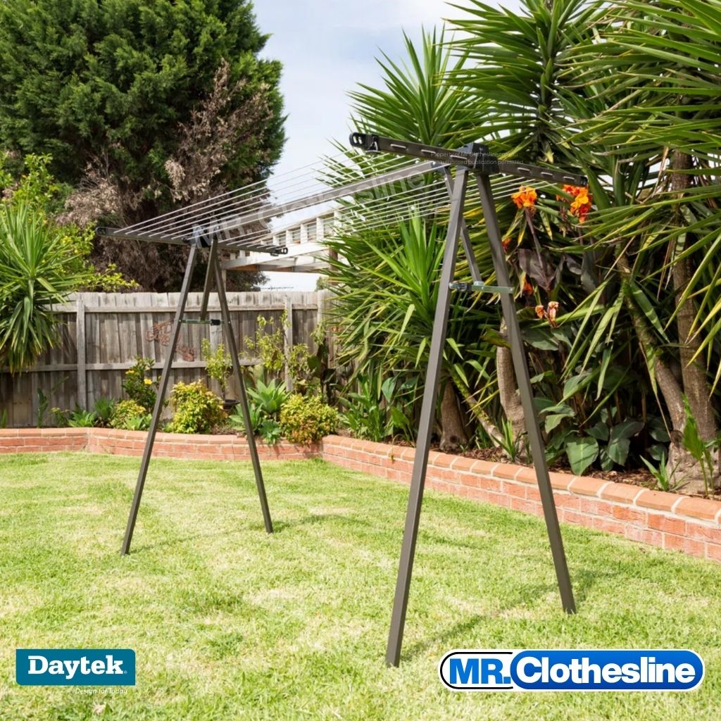 Daytek Portable Clothesline, in a backyard with Yakkas in the garden bed.