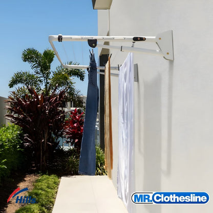 Hills Compact Fold Down Clothesline installed outside in Surfmist colour with washing hanging on the drying lines.