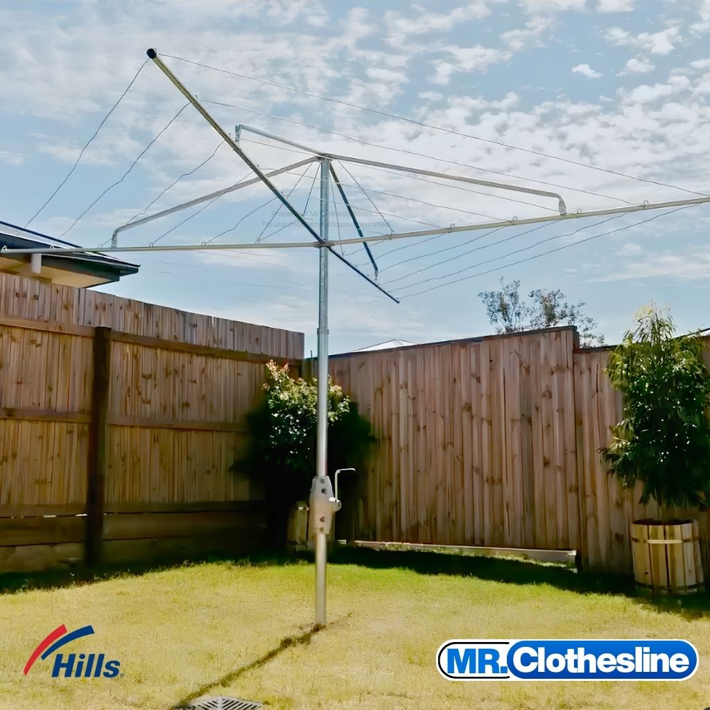 Hills Fixed Head Rotary Clothesline 6 Lines Installed in an Australian Backyard timber fence in the background.