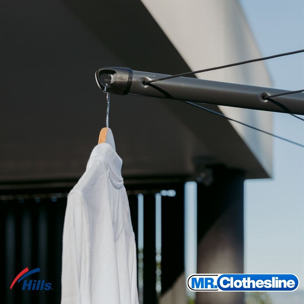 Hills Folding Rotary 7-Line Clothesline arm tip coathanger hook in Monument colour with white shirt hanging on wooden hanger