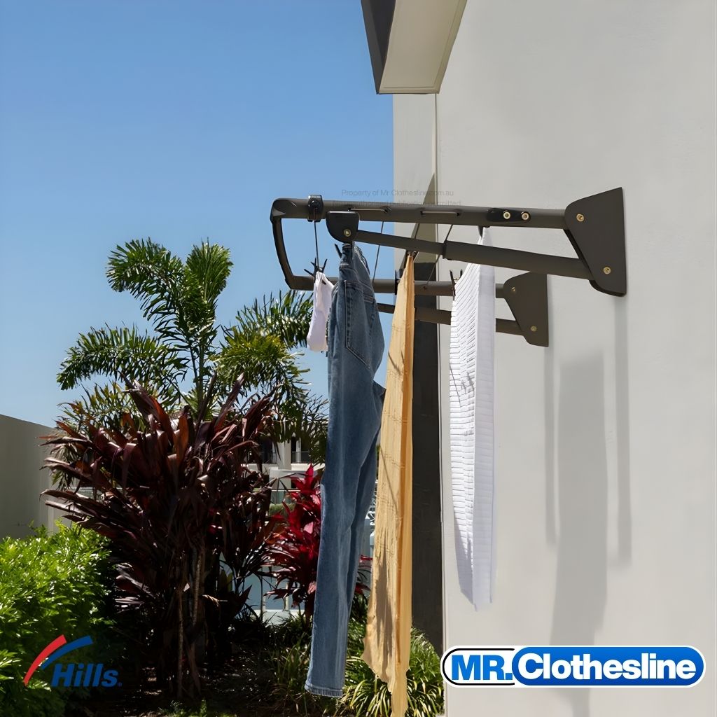 Hills Long Fold Down Clothesline installed outside in Monument colour with a full load of washing hanging on lines.