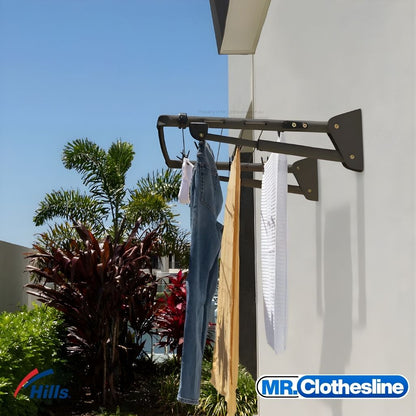 Hills Long Fold Down Clothesline installed outside in Monument colour with a full load of washing hanging on lines.