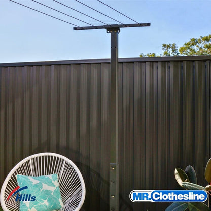 Hills Retractable 7-Line Clothesline installed on a ground post with receiving bracket outdoors.