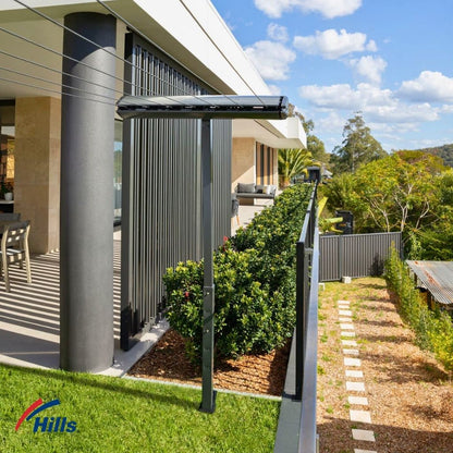 Hills Retractable 7-Line Clothesline lifestyle installed in backyard with lines extended.